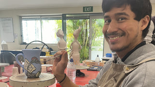 Michael painting a ceramic piece at Monte Lupo Arts Studio